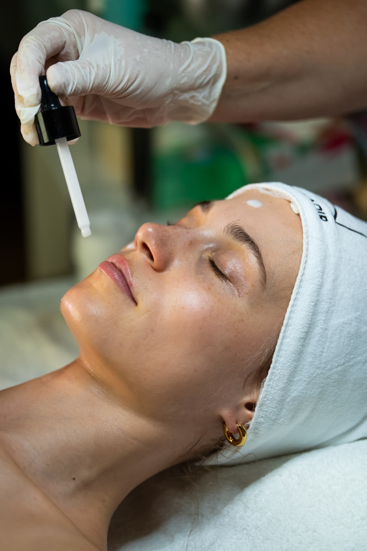 Vitamin C serum applied with a pipette during the facial